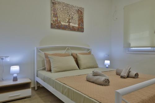 a bedroom with a bed with two pillows on it at antonis new apartment's 1 in Katerini