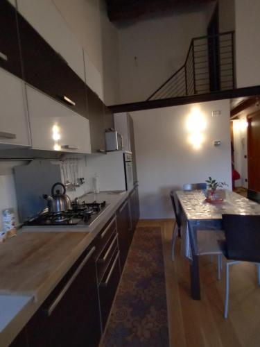 a kitchen with a stove and a table in it at La casa di Blue in Padova