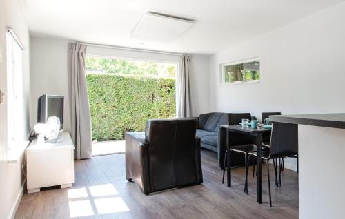 a living room with a couch and a table at 54, Prachtige natuur voor fietsers! in Oisterwijk