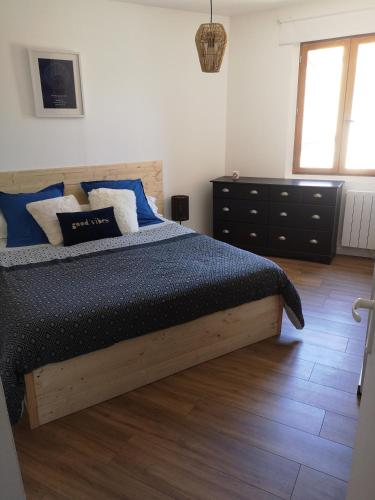 une chambre avec un lit et une commode dans l'établissement Maison Entière Hameau Monastir del Camp, à Passa