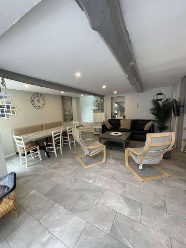 un grand salon avec des chaises et une table dans l'établissement La Maison Bleue, proche de tout, au Tréport