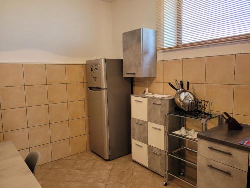 a kitchen with a stainless steel refrigerator in a room at Domus Quarticelli Costa dei Trabocchi in Torino di Sangro