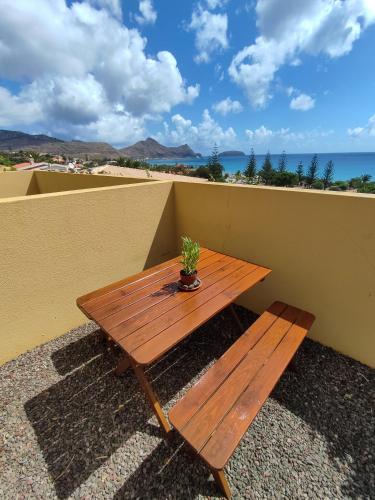 a wooden table with a potted plant sitting on a roof at Bela Vista Capazi in Porto Santo