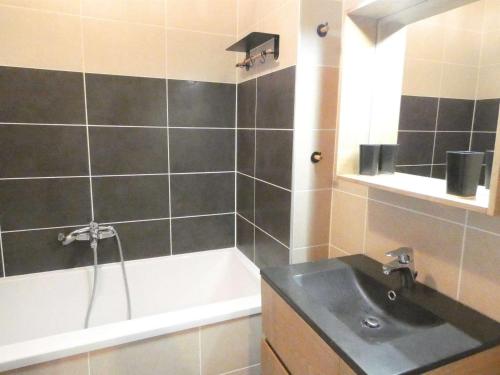 a bathroom with a sink and a bath tub at Appartement Saint-Lary-Soulan, 2 pièces, 4 personnes - FR-1-457-282 in Saint-Lary-Soulan