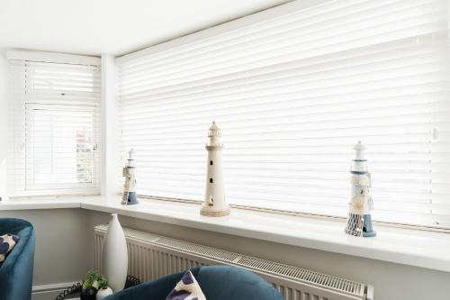 a window sill with two lighthouse figurines on it at Birkby Lodge Escape in Lytham St Annes