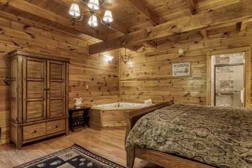 a bedroom with a bed and a tub at Camelot #266 in Pigeon Forge