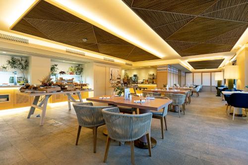 a restaurant with tables and chairs in a room at Hospes Maricel y Spa, Palma de Mallorca, a Member of Design Hotels in Cas Catala