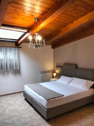 a bedroom with a large bed and a chandelier at Bed & Breakfast De Nittis in Barletta