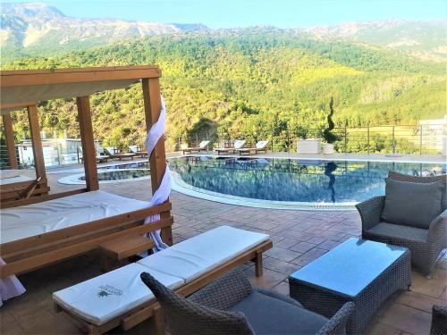 a resort with a swimming pool with chairs and a bed at Sunny Side apartment in Bečići