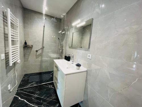a white bathroom with a sink and a shower at CASA ALTEA in La Chapelle-de-Guinchay