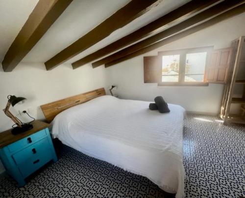 a bedroom with a white bed and a window at Casa Violeta in Altea