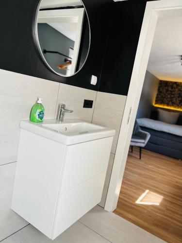 a bathroom with a white sink and a mirror at Kirchberg in Volkach