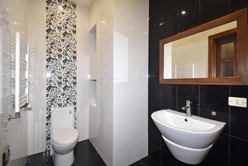 a bathroom with a white sink and a toilet at Homestay at City Center in Yerevan