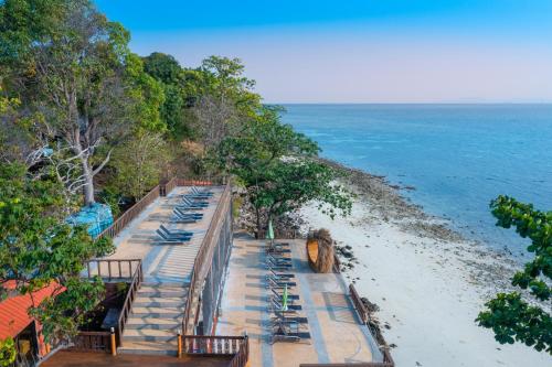 an overhead view of a beach with lounge chairs and the ocean at Phi Phi Natural Resort in Phi Phi Don