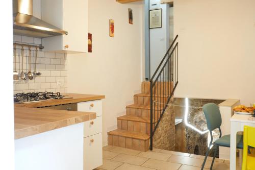 a kitchen with a staircase and a kitchen with white cabinets at Relax & Peace in the Historic Center by Host Hero in Lapedona