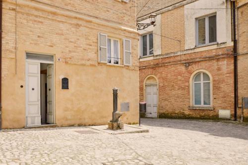 an empty street in front of a brick building at Relax & Peace in the Historic Center by Host Hero in Lapedona