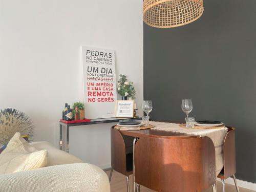 a dining room with a table and chairs with wine glasses at Lisbon, renovated T2 apartment Portas de Benfica in Amadora