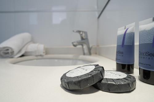 two tires are sitting on a bathroom sink at Golf Residence Sea and Soul in Eilat