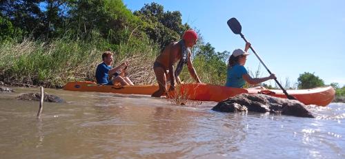 a group of three people in the water with a kayak at 4 Pohon - Les 4 Arbres in Pandang