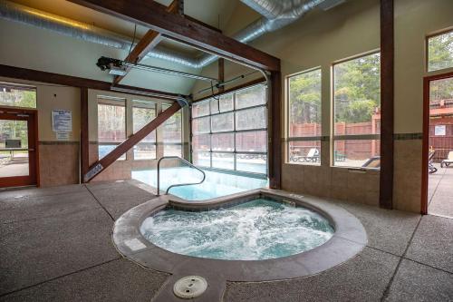 a hot tub in the middle of a building with windows at Los Pinos Columbine Condo Nice Updates Stroll to Lift in Breckenridge