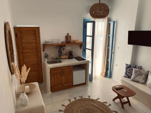 a living room with a sink and a kitchen at BLUE IN NAXOS in Naxos Chora