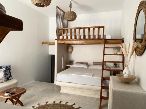 a bedroom with a bunk bed and a ladder at BLUE IN NAXOS in Naxos Chora
