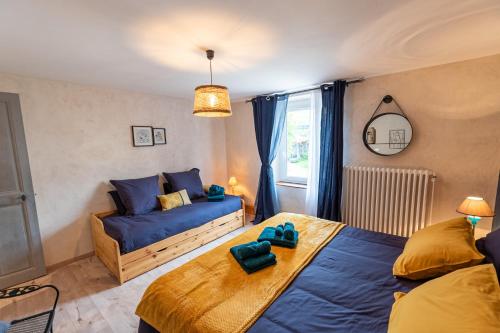 a bedroom with two beds and a couch at chambres d hotes Ysalice in Merlas