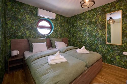 a bedroom with a bed with towels on it at ROOMS in Szombathely