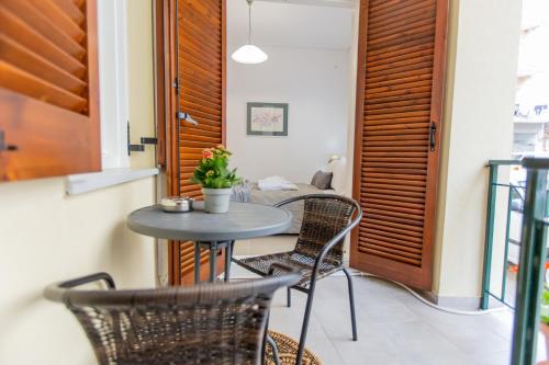 a small table and chairs on a balcony at Costos Condos NEW 10B 2 Bedrooms Condo in Nafpaktos