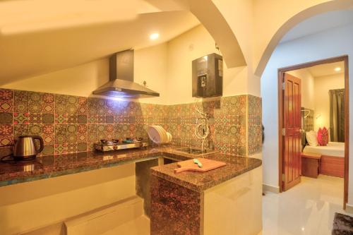 a kitchen with a counter top and a sink at Amazing 2BHK Apartment Near Baga Beach By Stay Over Home in Baga