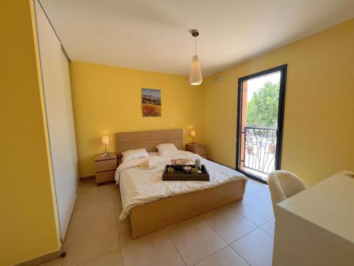 a bedroom with a bed and a large window at Appartement Fréjus, 3 pièces, 4 personnes - FR-1-226A-290 in Fréjus