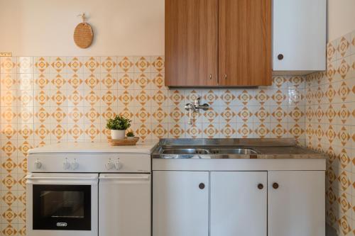 a kitchen with a sink and a stove at Lungomare 90 - YourPlace Abruzzo in Fossacesia