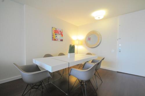 a dining room with a white table and chairs at 2 BR 1.5t Bath in Midtown West in New York