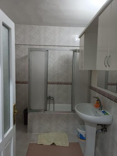 a bathroom with a shower and a sink and a sink at hamdihome in Akcaabat