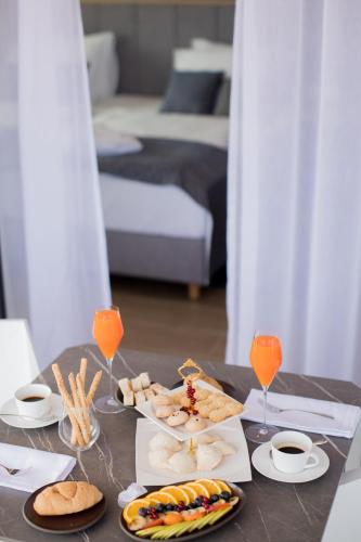 a table with a tray of food and wine glasses at Hotel Crystal in Orebić