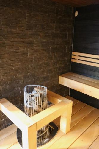 a bench with a bird cage next to a bench at Liirakka Levi in Levi