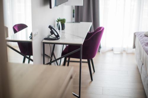 a table with a pair of shoes on it in a room at Hotel Crystal in Orebić
