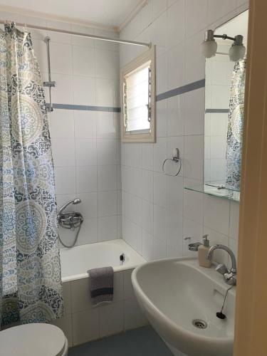 a bathroom with a tub and a sink and a toilet at Dialinas Apartments in Istro