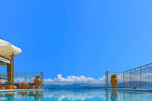 a swimming pool with a view of the water at Villa Rose above Agni with amazing views in Kavalléraina