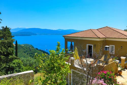 a house with a view of a body of water at Villa Rose above Agni with amazing views in Kavalléraina