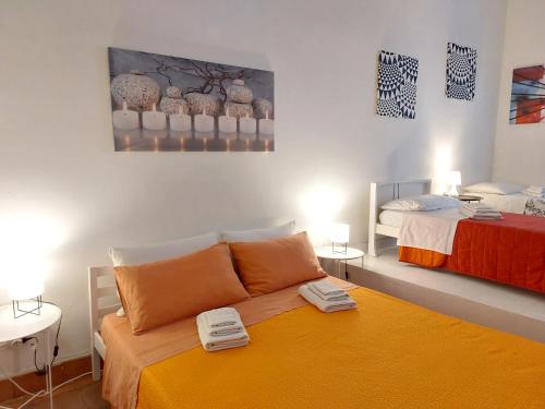 a room with a bed and two beds in it at Casa Cenzina in Cosenza