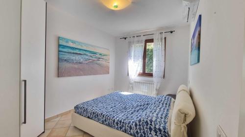 a bedroom with a bed and a window at Appartamento Blu Relax in Capoliveri