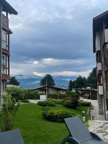 a view of a yard with two buildings at Allure in Pirin Golf in Razlog