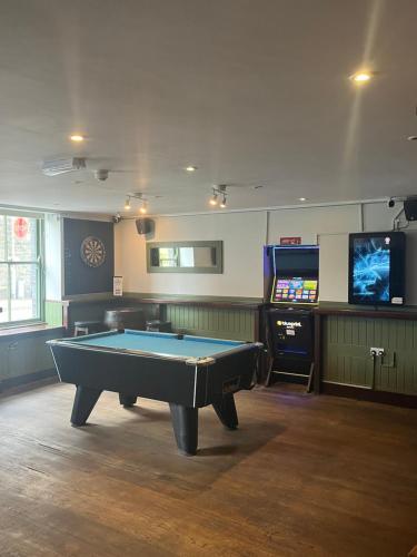 a room with a pool table and a flat screen tv at Hampton Hotel & restaurant in Llandrindod Wells