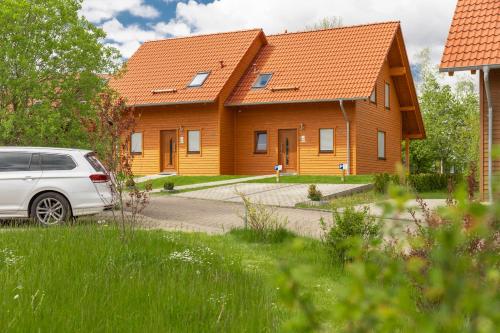 a white car parked in front of a house at Ferienhaus Asgard in Hasselfelde