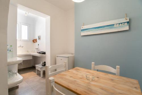 a bathroom with a table and a sink and a toilet at Livadia Seaside Studios 1 in Parikia