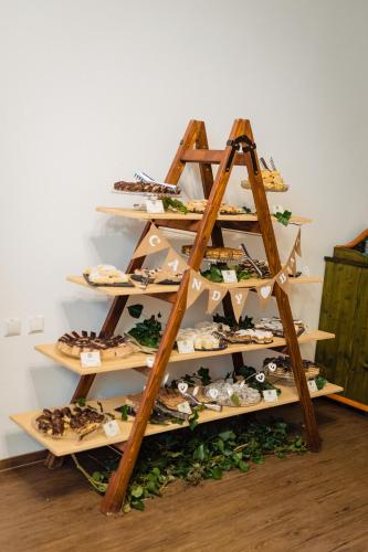 a shelf filled with different types of pastries at Conacul Secuiesc-Székelykő Kúria in Colţeşti
