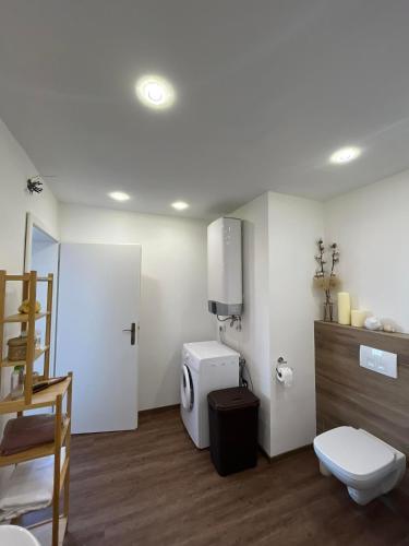 a white bathroom with a toilet and a sink at Apartment and Studio Ivan Dolac in Ivan Dolac