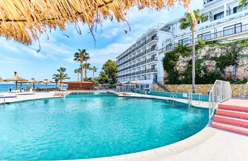 a swimming pool in front of a hotel at Leonardo Royal Hotel Mallorca in Palmanova