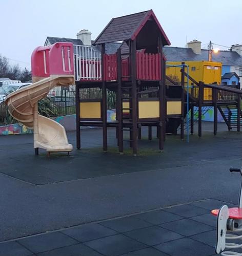 a playground with a slide in a park at No 14 Holiday Village House, Sneem, 4 bedrooms in Sneem